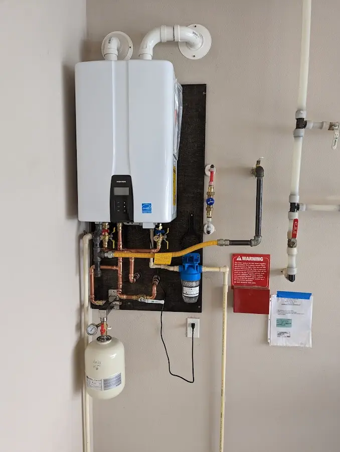 Professional plumber installing copper piping in a Rockwood home